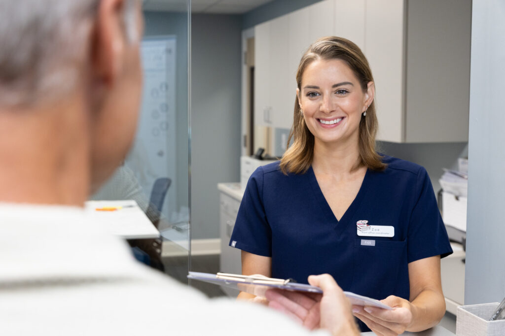 An InterveneMD provider helps a patient check-in for their appointment to find a fibromyalgia treatment in Charleston, SC.