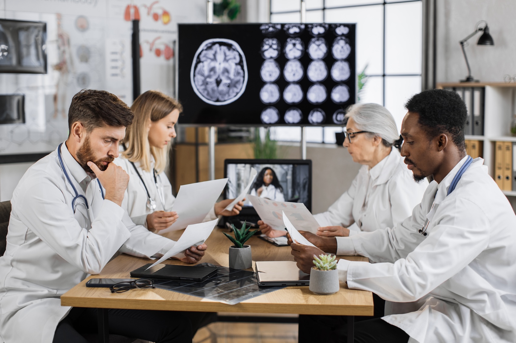 A group of physicians examine a patient's brain scan before advising Alzheimer's disease treatment in Charleston.
