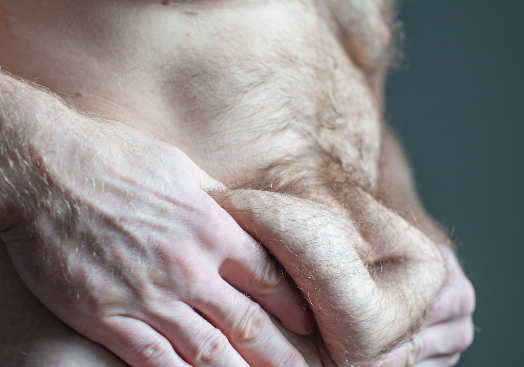 A man struggles with unwanted abdominal fat and an irregular metabolic rate, both of which he can address with our gut health doctor in Charleston.