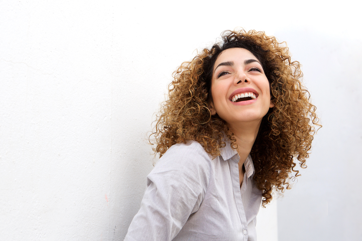 A woman is smiling after her treatment for facial contouring in Mt. Pleasant, SC.