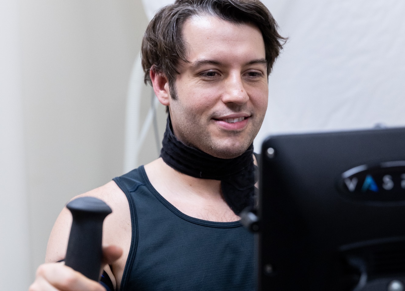 A patient enjoys therapeutic exercise with the Vasper System at InterveneMD.