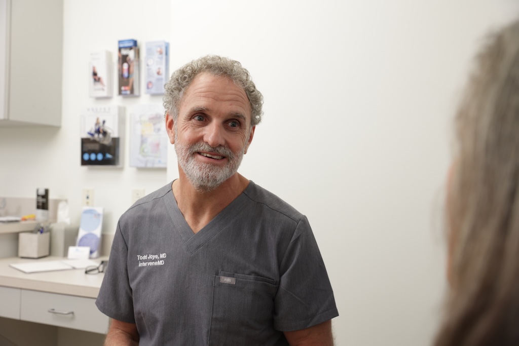 Dr. Todd is sitting with a patient who has a specific health condition she wants to discuss before starting NAD in Charleston.