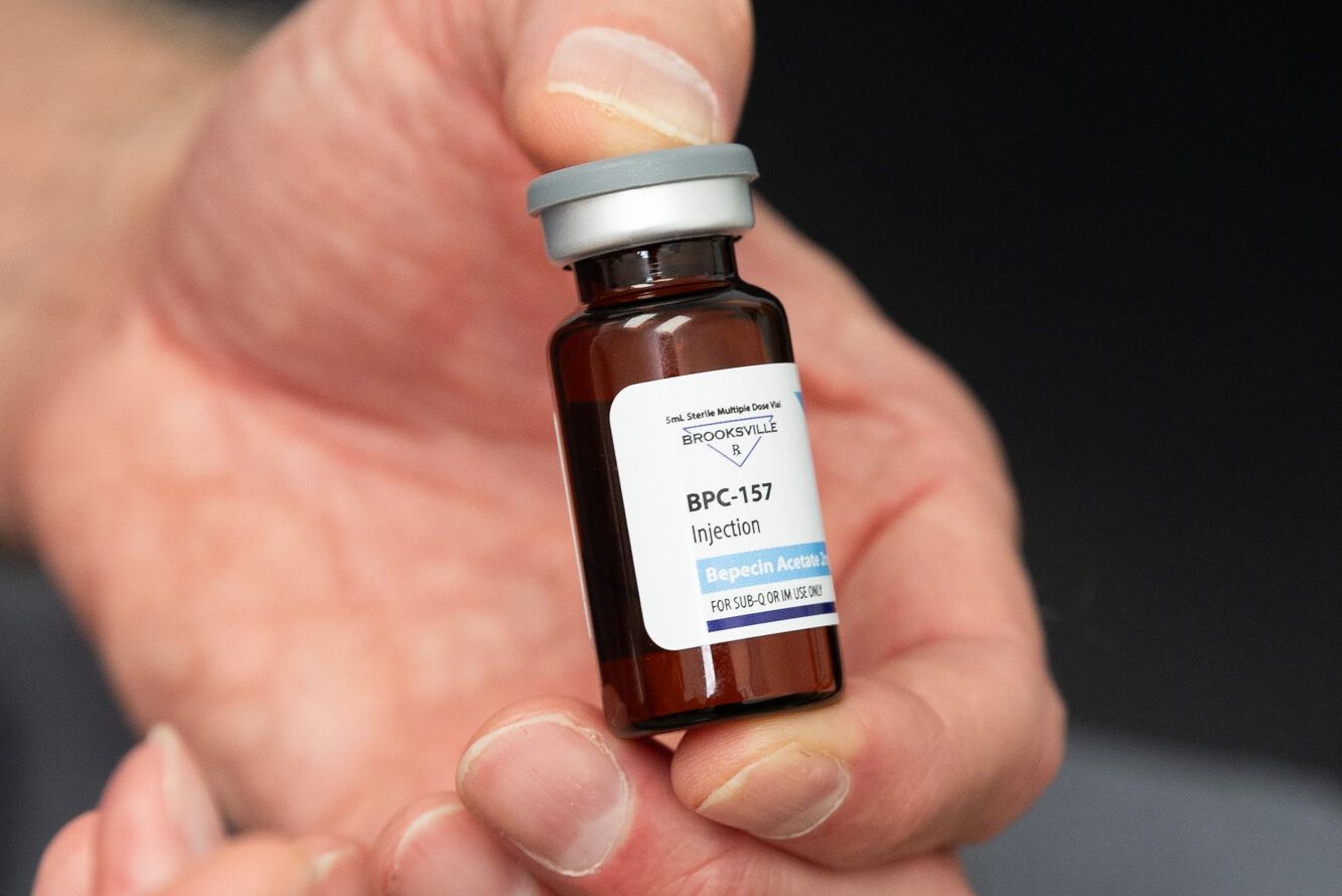 An InterveneMD provider holds a vial of injectable BPC-157, a peptide often used to support patients' long COVID treatments in Charleston.