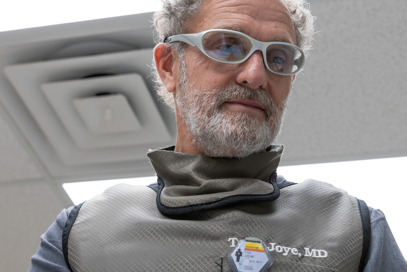 Dr. Joye looks down at the patient as he delivers MLS laser therapy in Charleston.